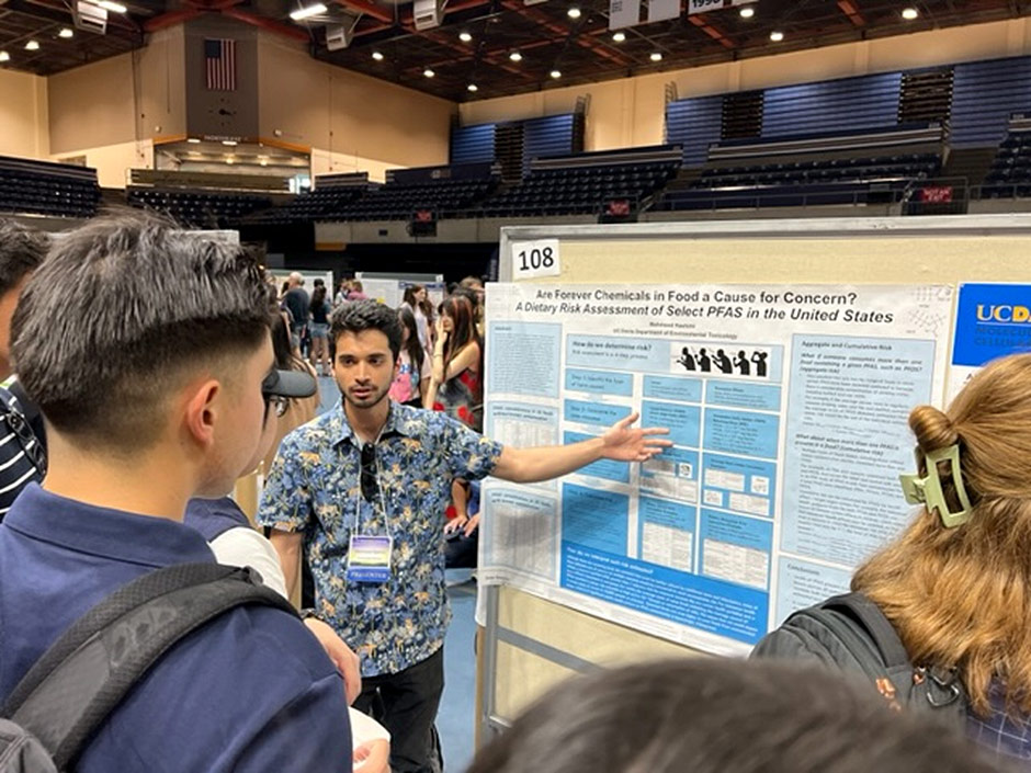 Brief description of Photo: Mahmood Hashimi presenting his risk assessment research on PFAS in food packaging. Photo Credit: Elizabeth Marder