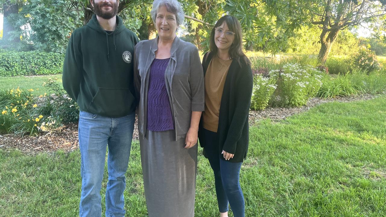 Zeke Spooner (left), recipient of the 2025 Alexeeff Award, stands with Jean Ackerman (center), spouse of the late Dr. George Alexeeff, and Dr. Christina Pasparakis (right) in a garden setting following the award ceremony.