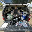 Researcher in car shows off samples collected from rivers